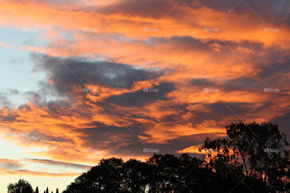 Sun setting during an afternoon thunderstorm