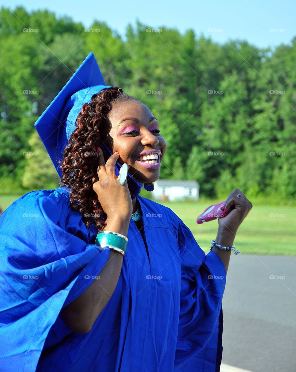 Happy Graduate talks on cell phone