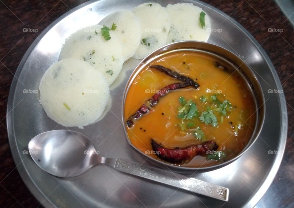 South Indian Dish- Idli Sambar. It is a typical dish made from batter prepared from rice, urad dal, Bengal daal, and a few other kinds of cereal as well. Nowadays, people prefer making idlis from Semolina (Rava). 
