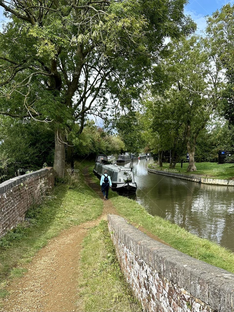 Walking along towpath in Brauston back to narrowboat moored along Oxford canal ready to head off and cruise back to Napton 