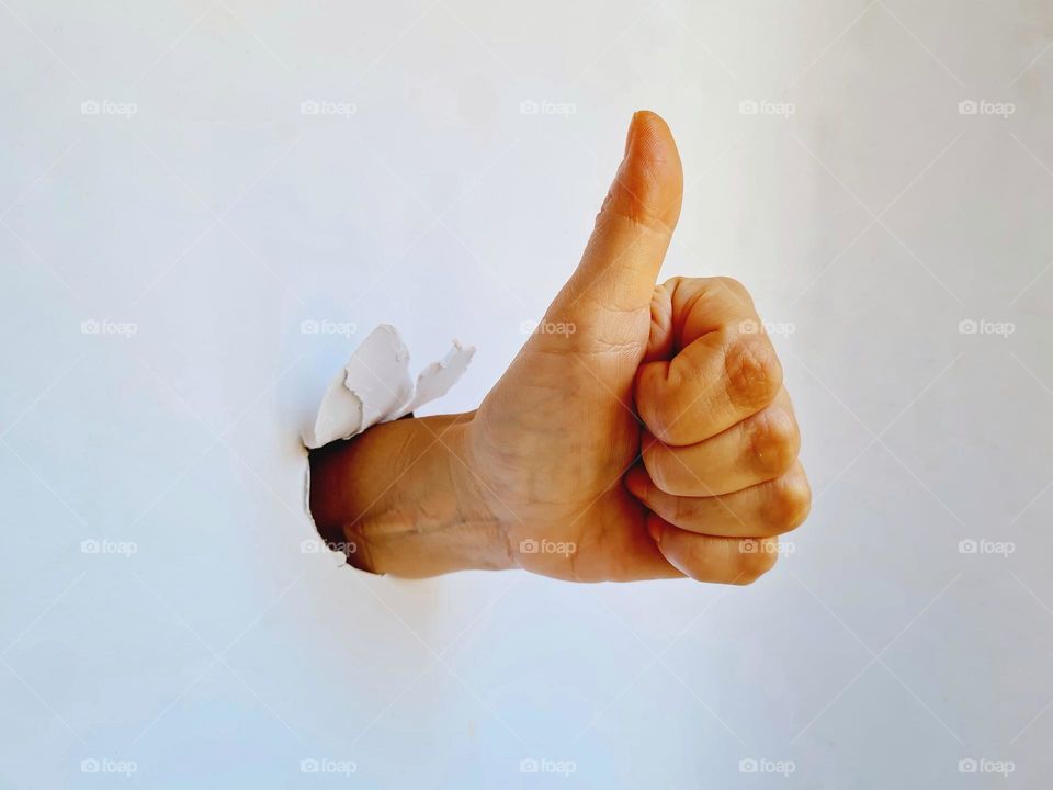 close-up of hand ok gesture on white background