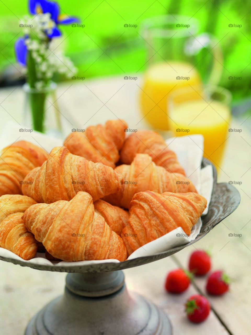 Croissants for breakfast with fresh orange juice  