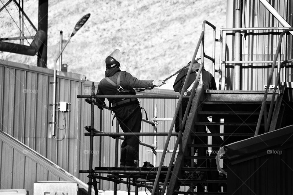 workers on metal platform construction b&w