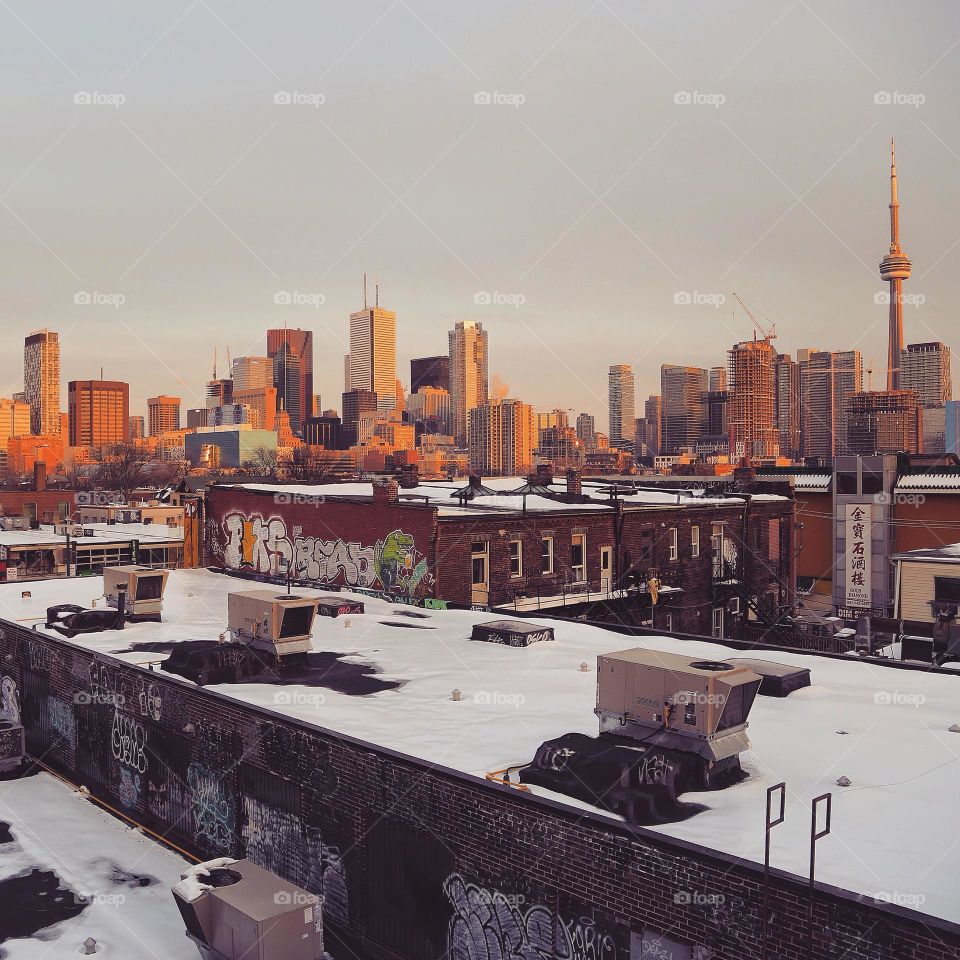CN tower and Toronto skyline from top of a building in Canada at sunset in winter