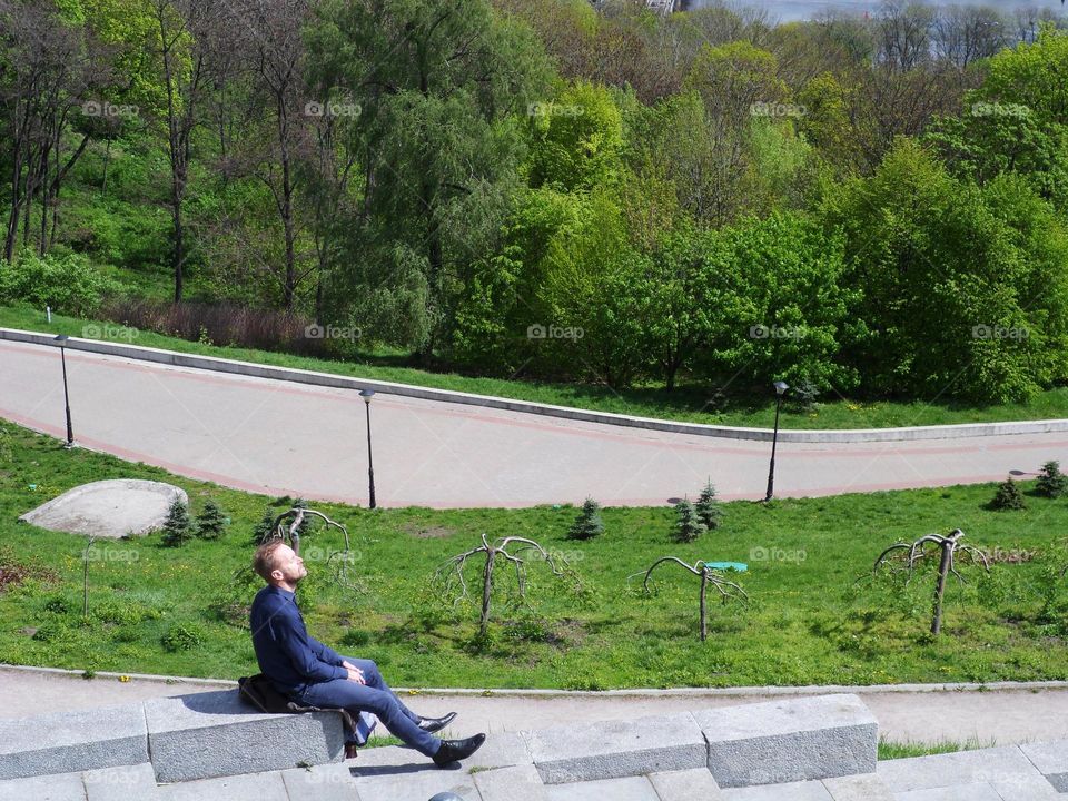 man resting in the park of the city of Kiev