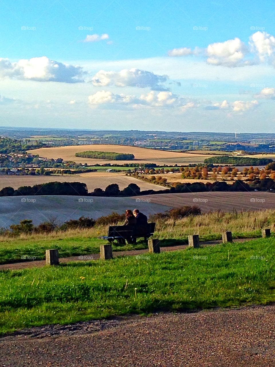 Couple on a bench taking in the view - Dunstable downs Bedfordshire England 