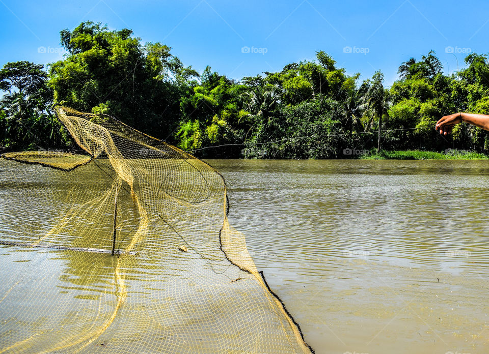 Close up of throwing a net to catching fish in the river
