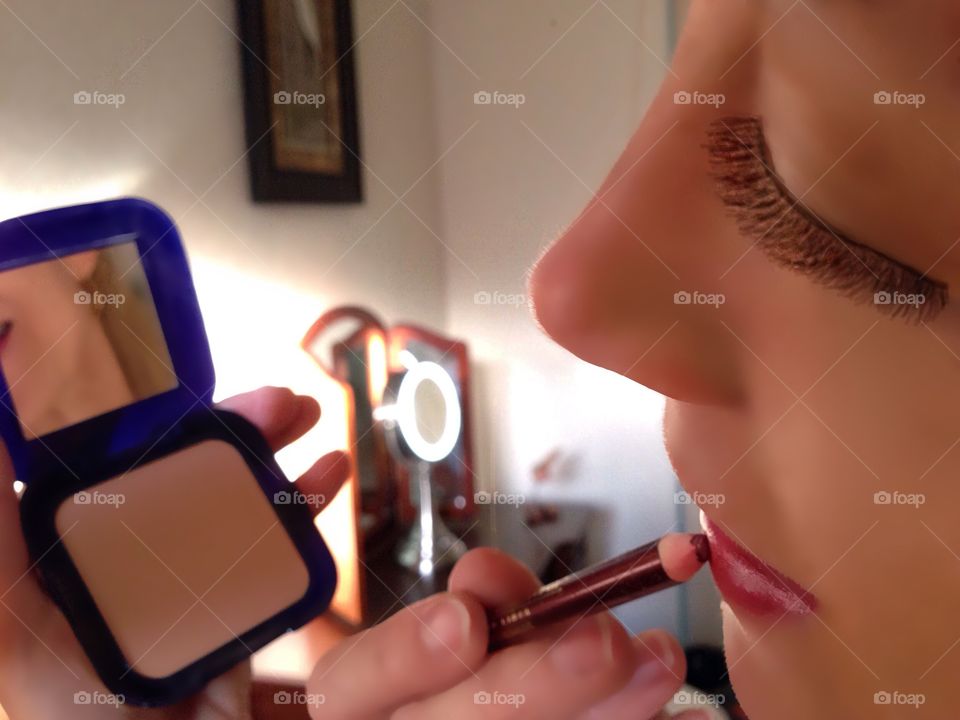 Woman applying cosmetics 
