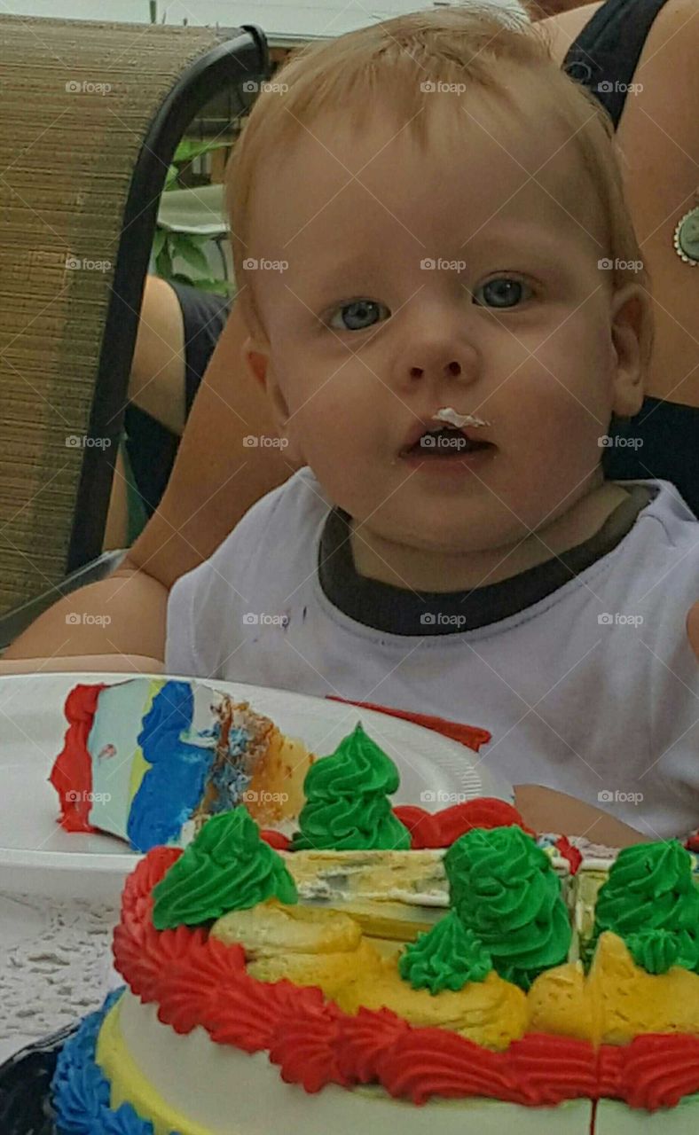 Close-up of a little boy eating cake
