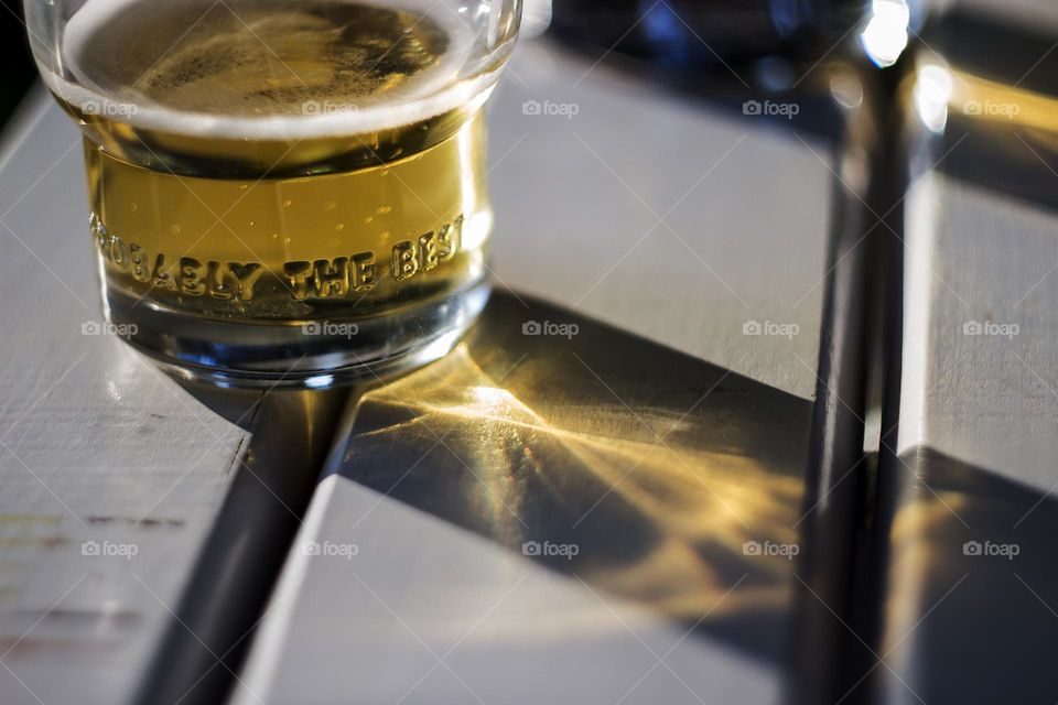 Sunlight reflection and glass of beer