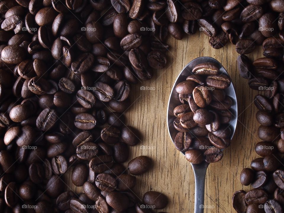 coffee beans on a spoon. coffee beans on a spoon