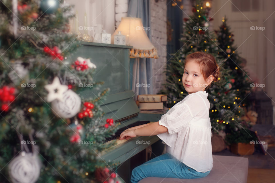 Cute girl playing piano