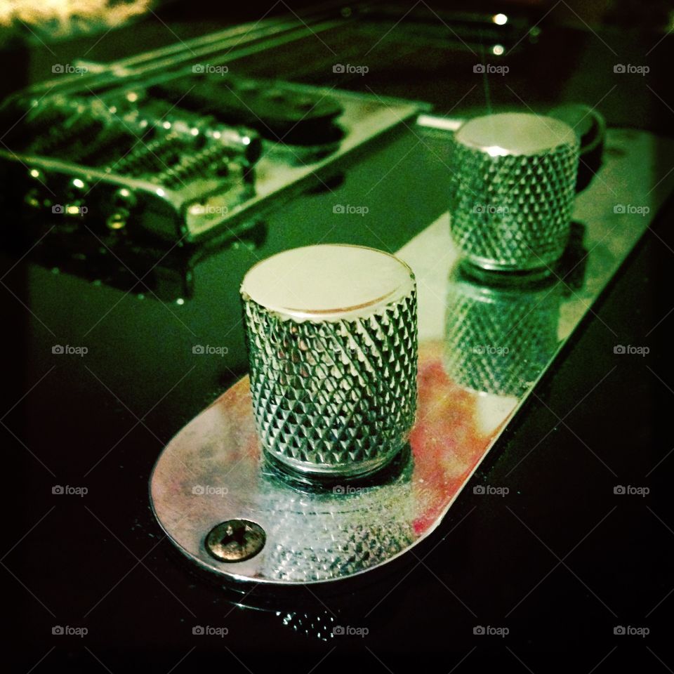 Close-up electric guitar knobs and dial strings 