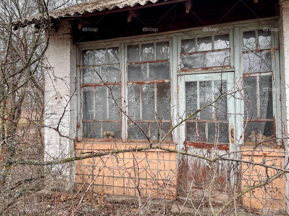 abandoned house and a toy on the window