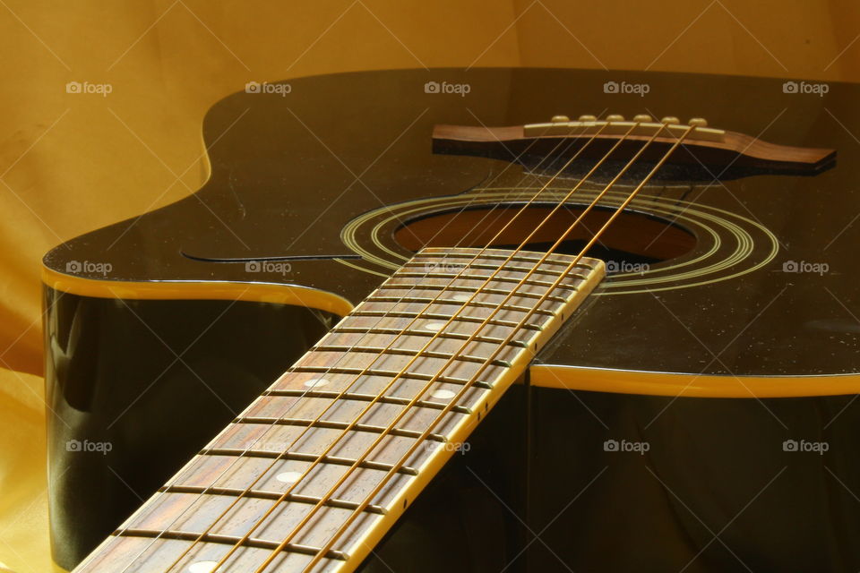 acoustic guitar on Golden textile