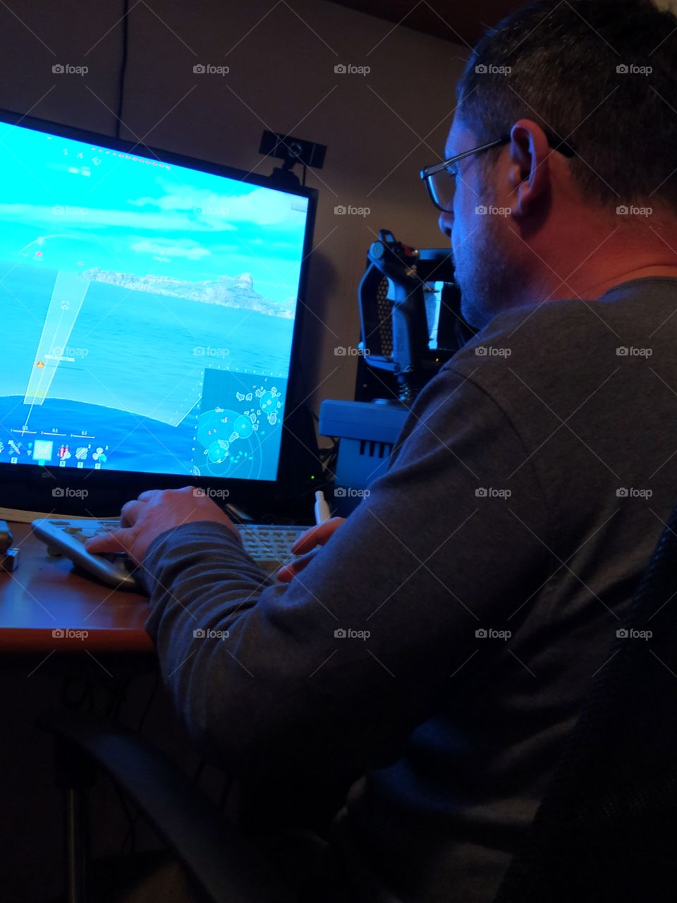 Evening.  Evening leisure.  A man sits and plays a computer game