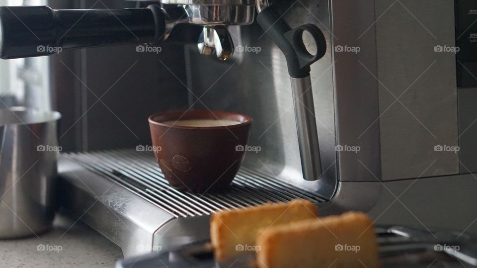 Machine pouring cup of espresso