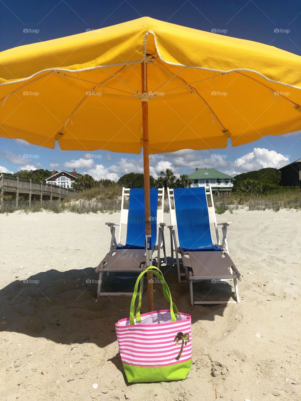 Beach umbrella and chairs at the seashore. 