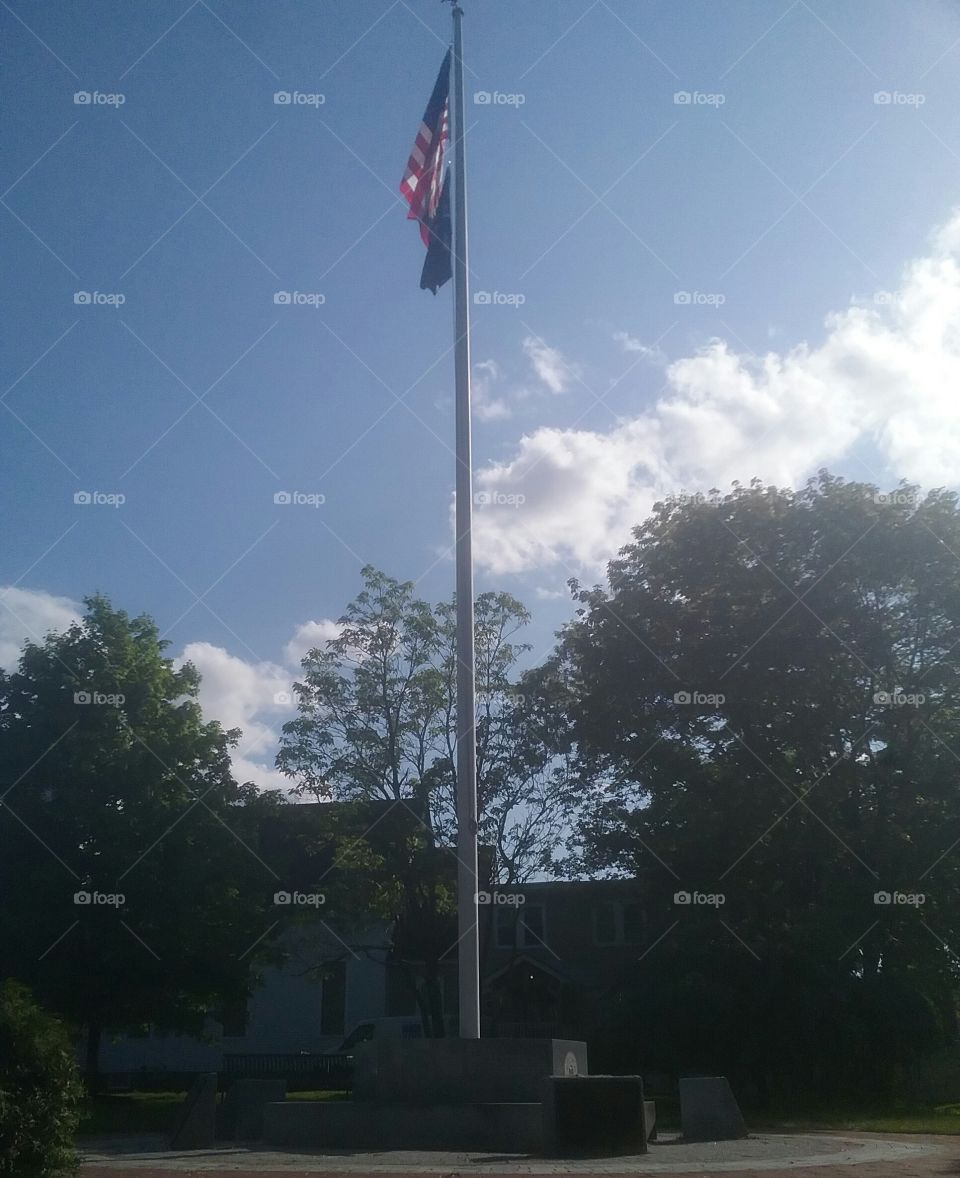 Old Glory flying proudly above the memorial stones