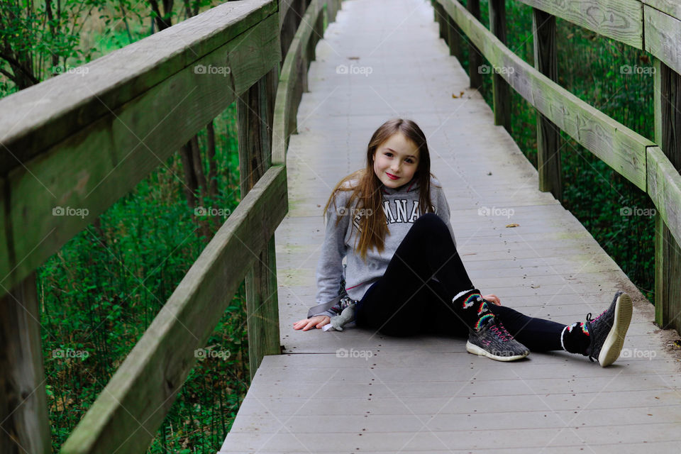 girl posing on a bridge