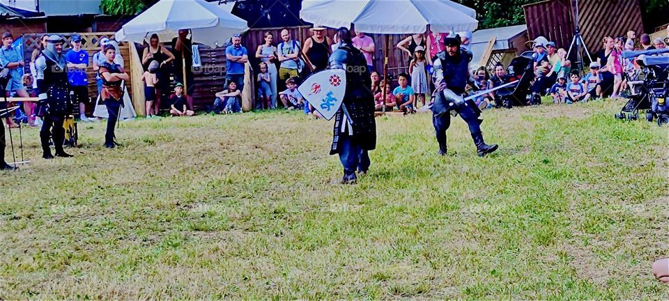 The knights displaying their skill with shields and swords and otherwise are actually regular 21st century people wearing medieval costuming to fit into the “Renaissance Festival” in “Ortenburg”, Germany. 2023. Hypnotic Productions