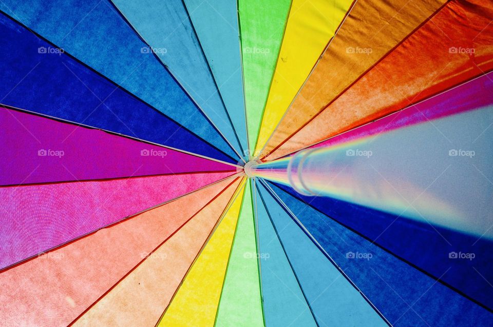 A rainbow coloured umbrella.