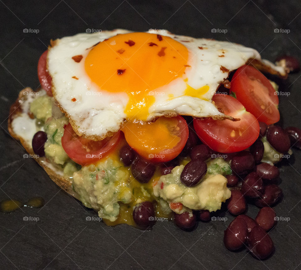 Fried eggs, black beans and homemade guacamole 