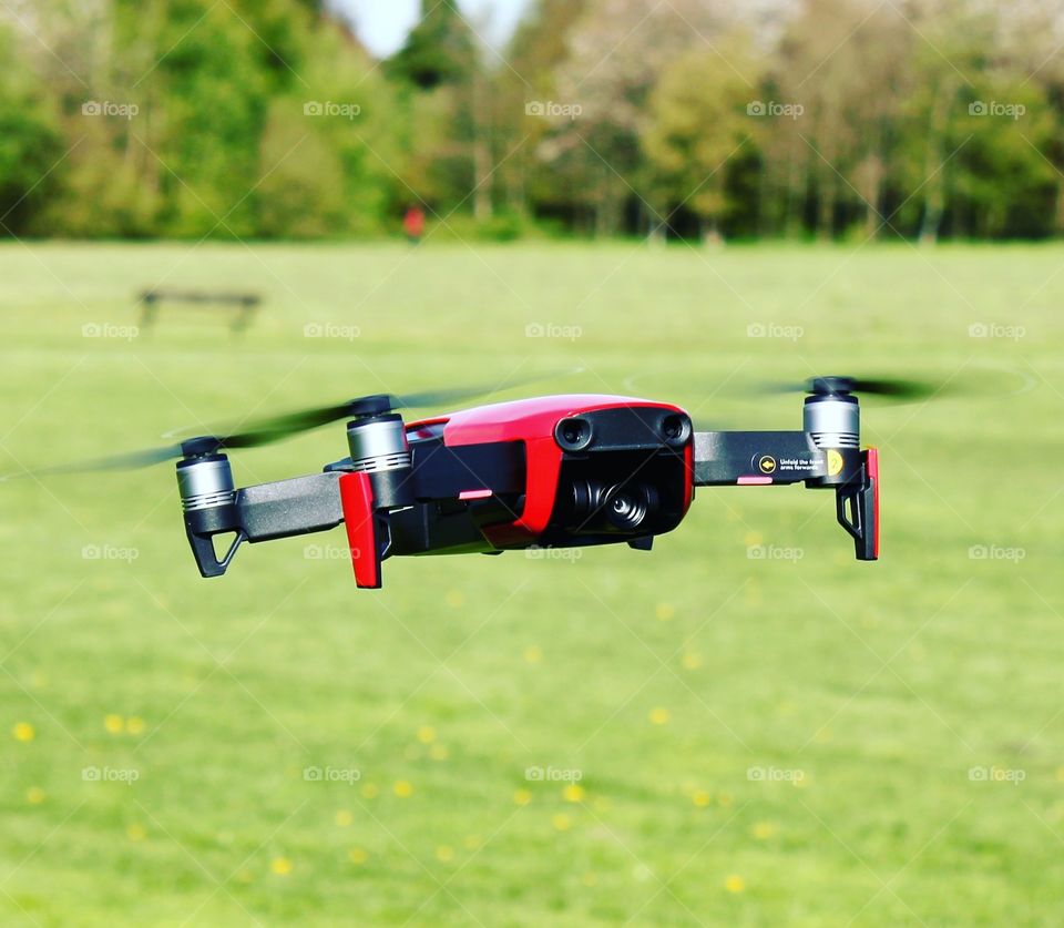 Drone hovering in field.