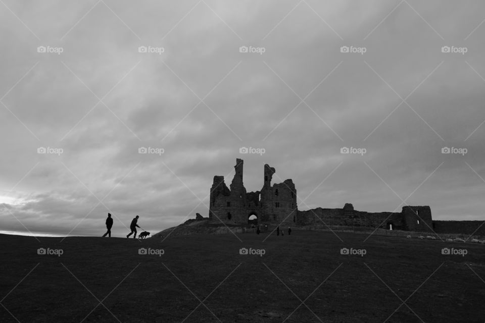 Dog taking it’s owner for a walk up a hill to a castle ... Minimalistic Mission 