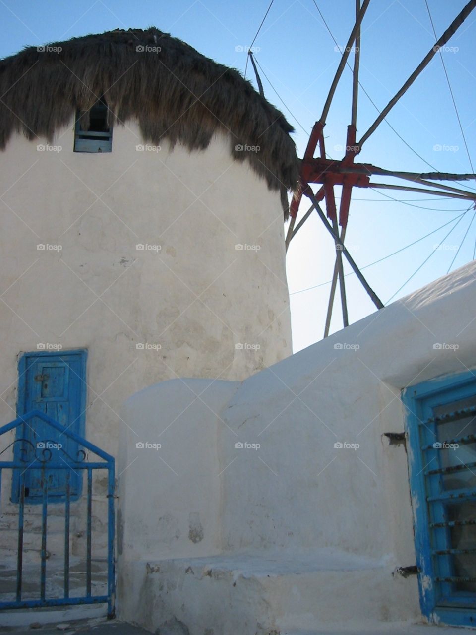Greek architectural windmill as the sun sets over the eastern side of the island