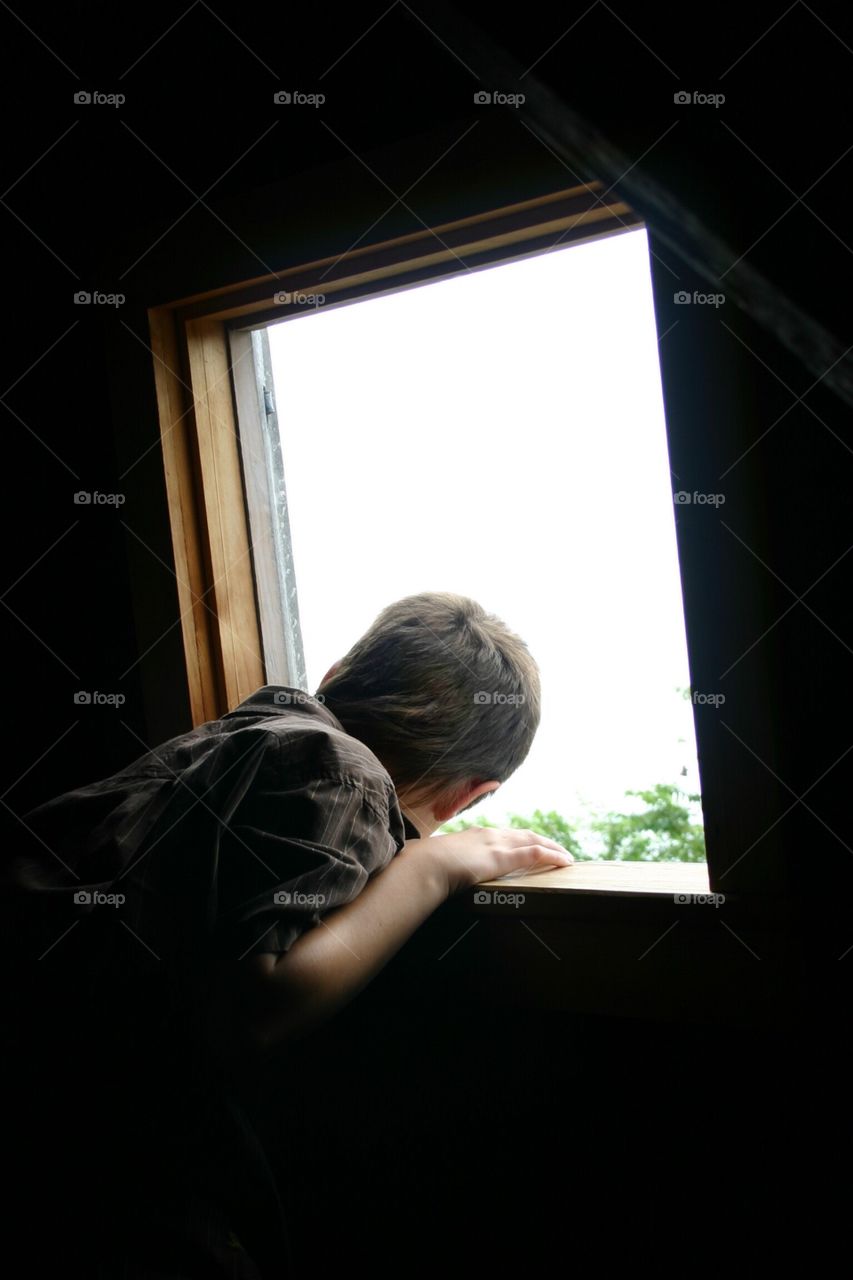 Checking out the scenery . Way up top of a wooden wood mill situated on a spot of land by the ocean in Cape Cod - windows of the world mission
