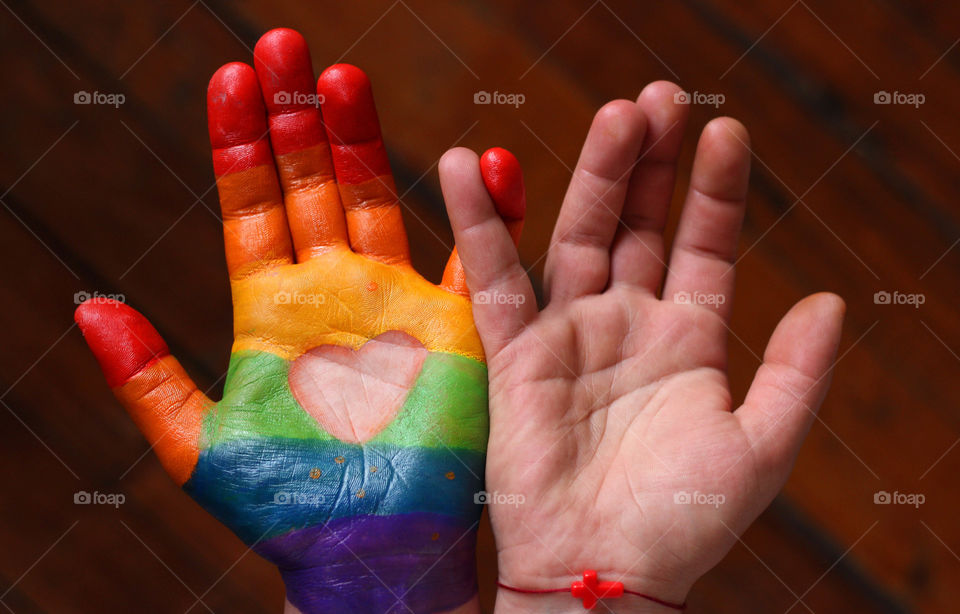 Love hearts, painted hands, rainbow colors, connected people