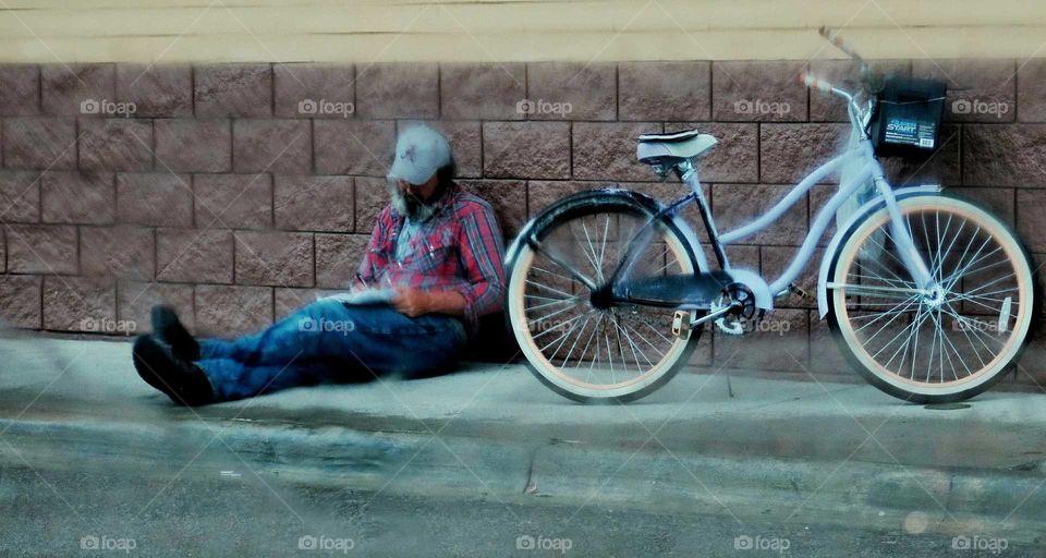 A homeless man and his bike.