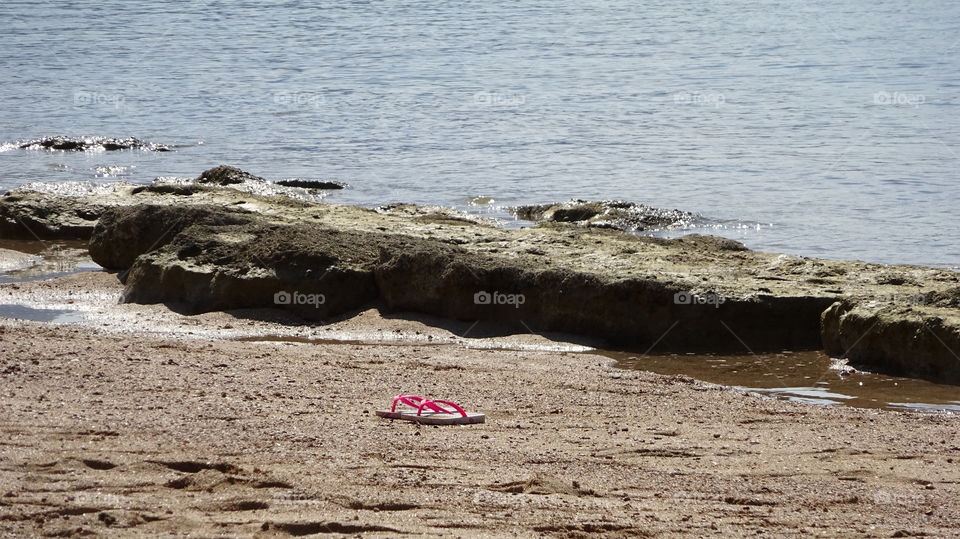 Pink slippers. Pink slippers on beach