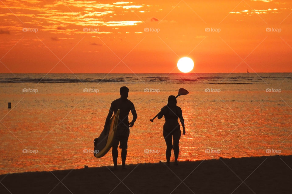 Two paddlers at sunset, Oahu, active hawaii mission

