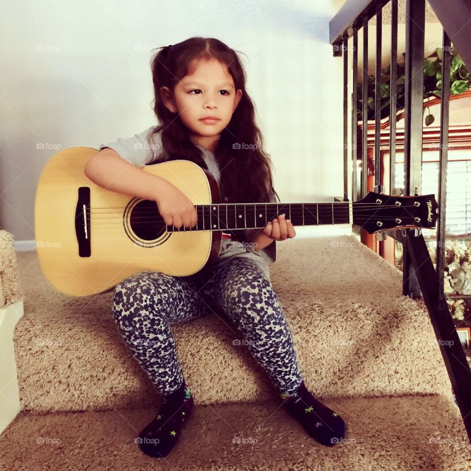 Little girl and her guitar