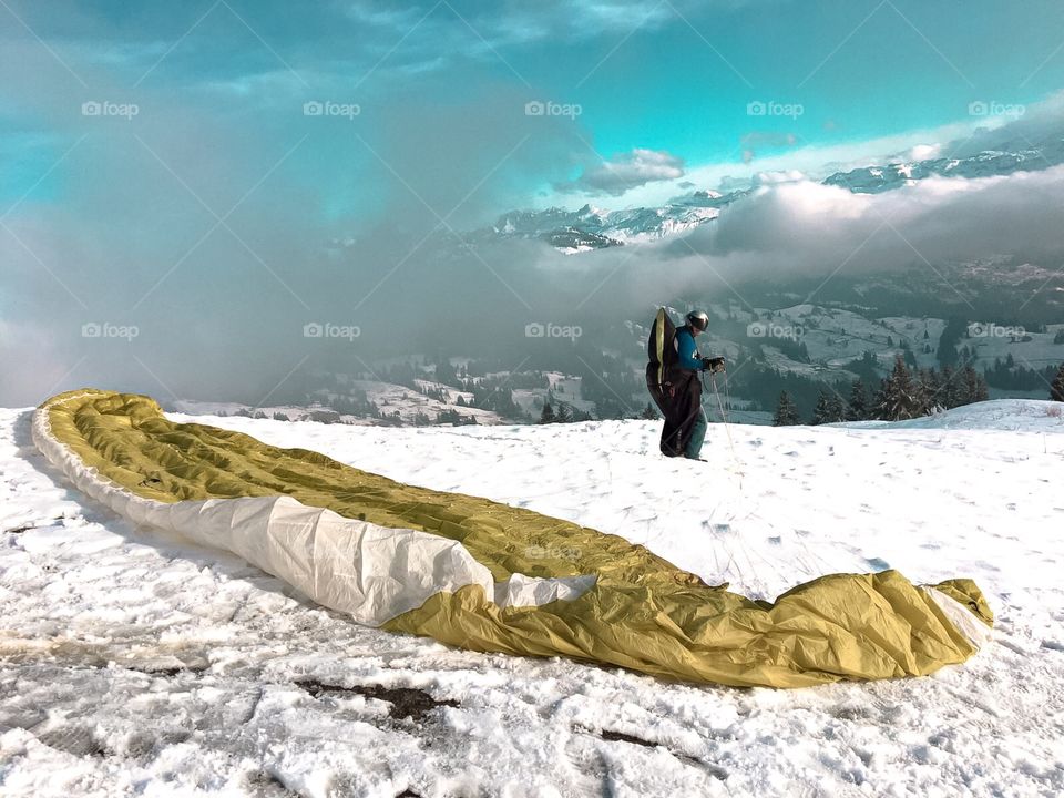 A man play paragliding on a mountain top