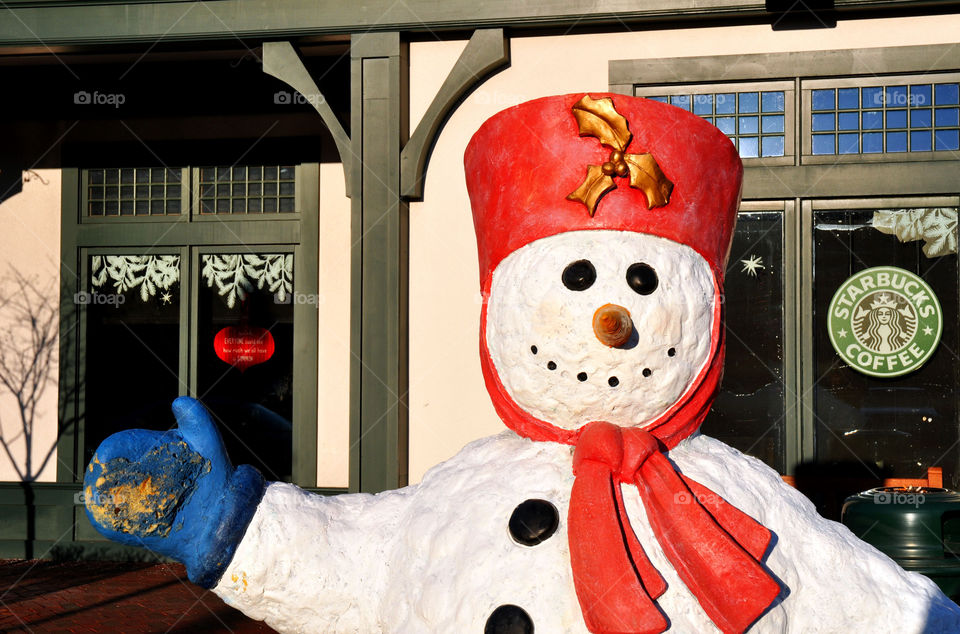 Snowman decoration in front of Starbucks coffee house. 