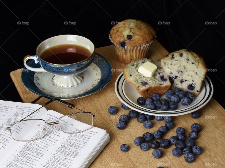 Enjoying blueberry muffins and tea for breakfast while reading the Bible