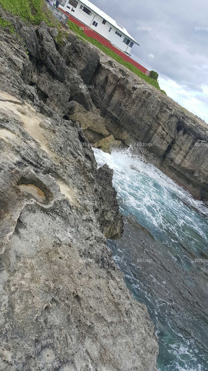 waves crashing on the cliff