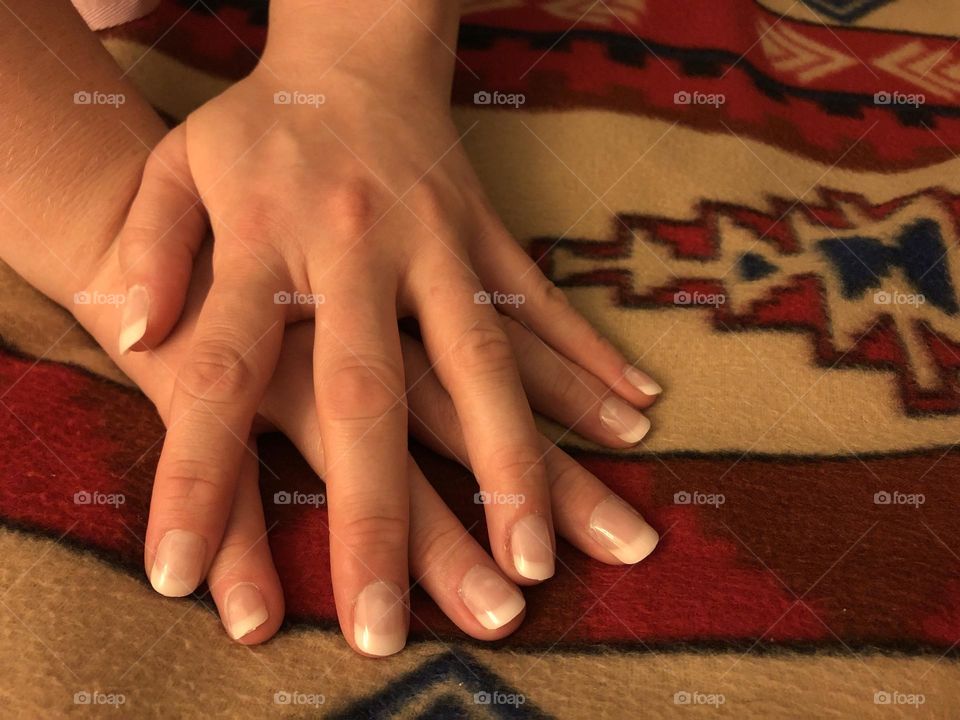 Hands long fingers against southwestern geometric background 
