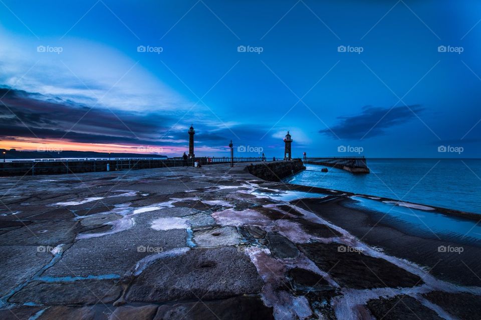 The two piers at dusk in the popular town of Whitby, North Yorkshire,