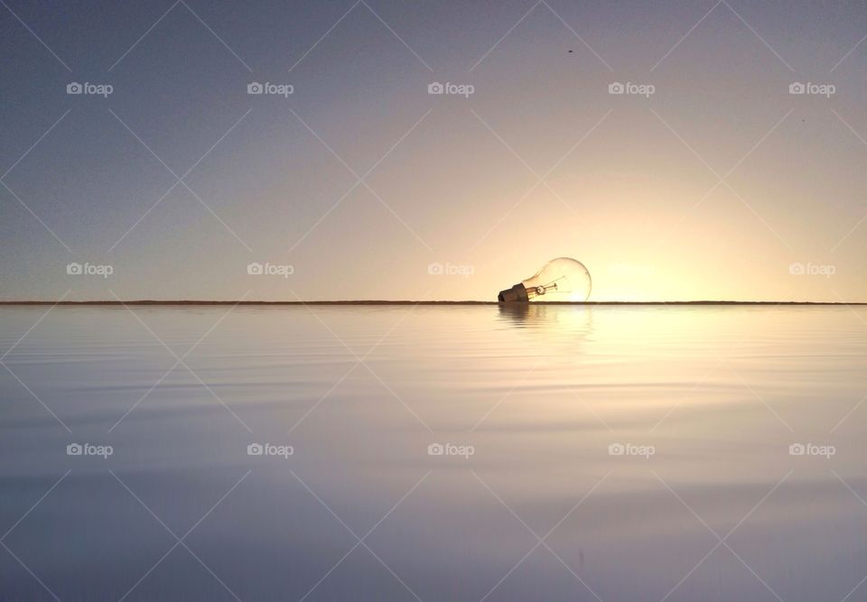 lamp in front of a sun at sunset