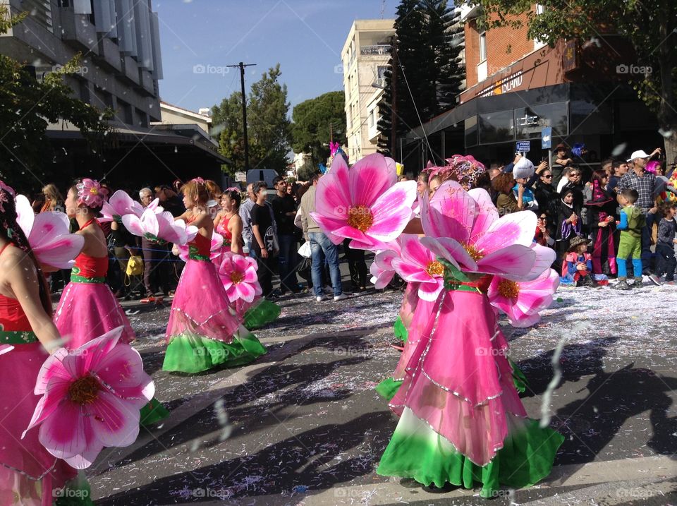 Women dressed as flowers walking in Carnival Parade.
