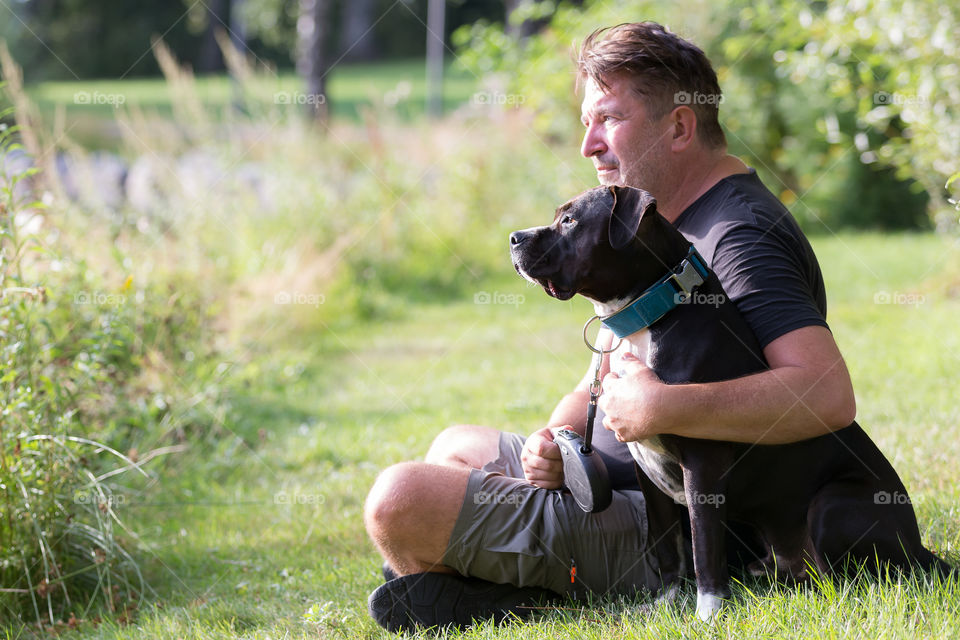 A man spending time with his dog , hobby 