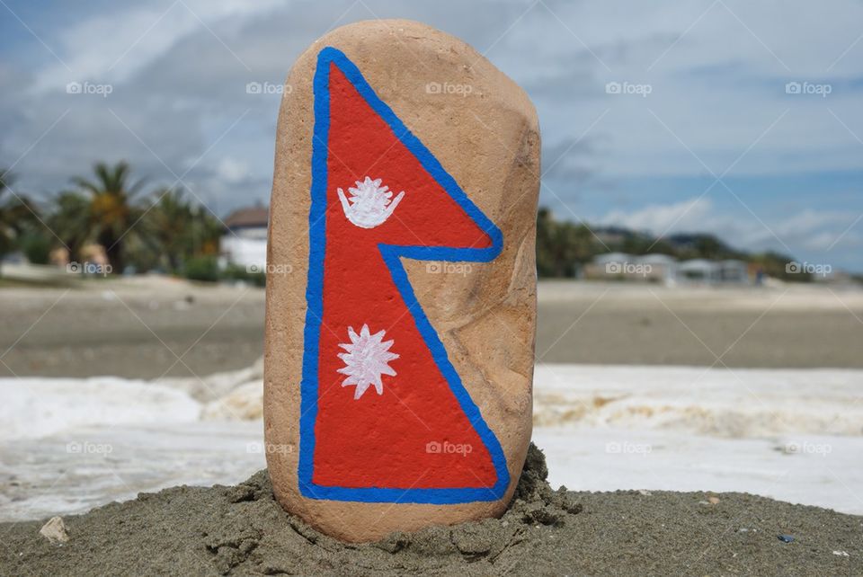 Nepal's flag on a stone