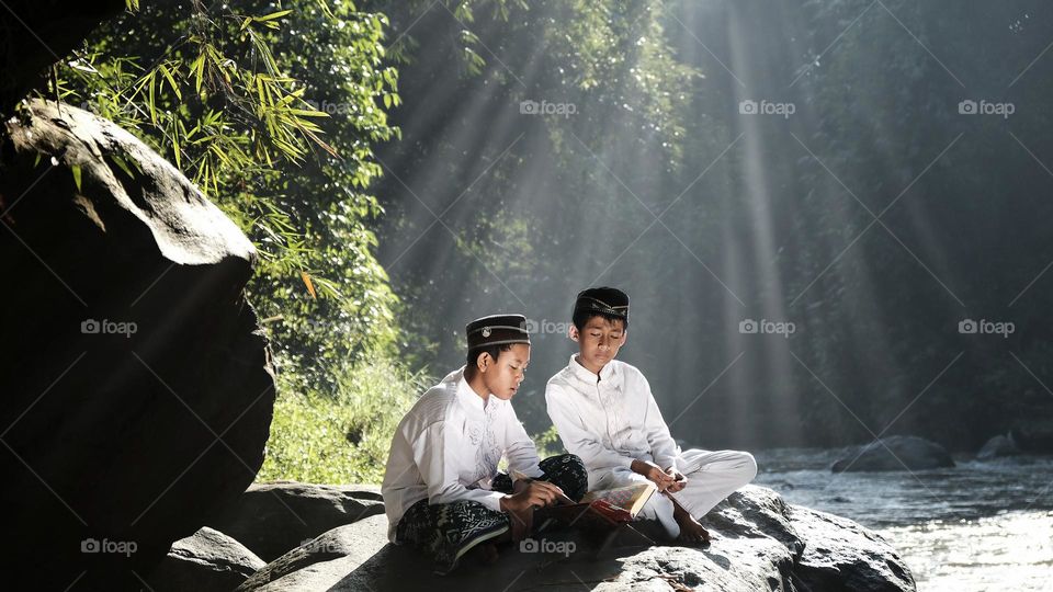 Brother and sister study in nature