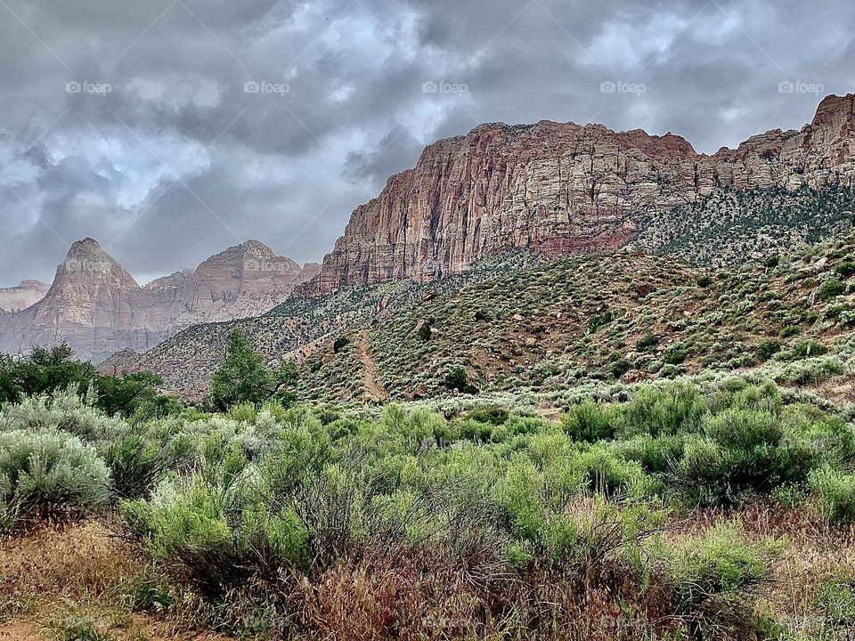 A photo of a cloudy sky with desert mountains below. 