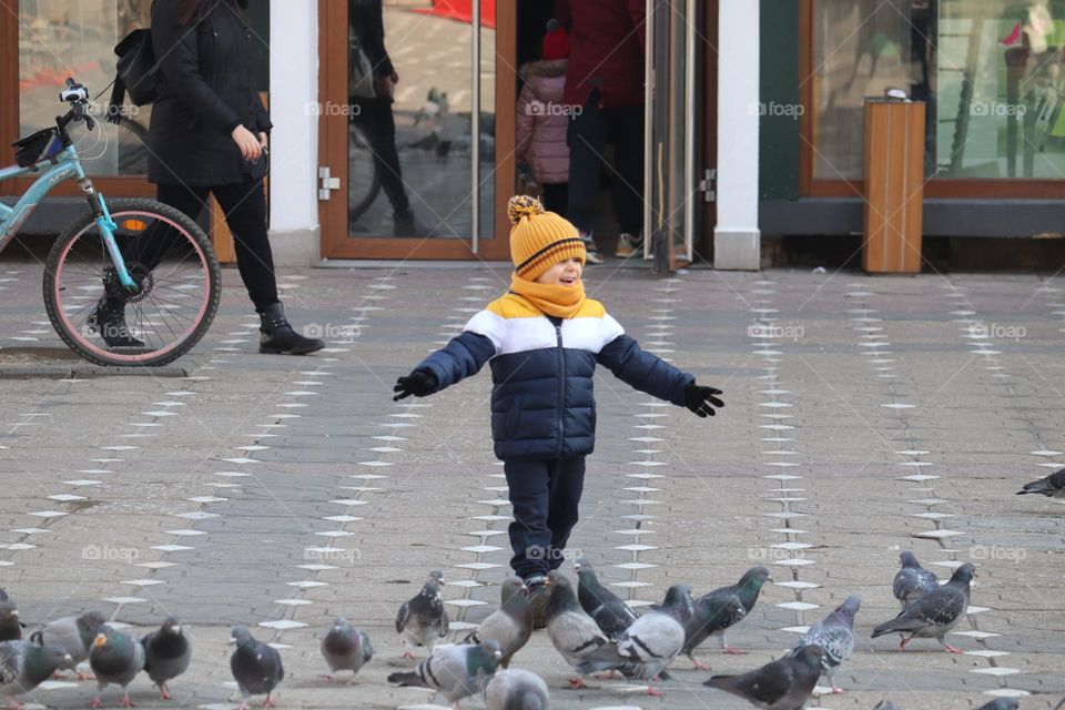 The boy playing at the pavement