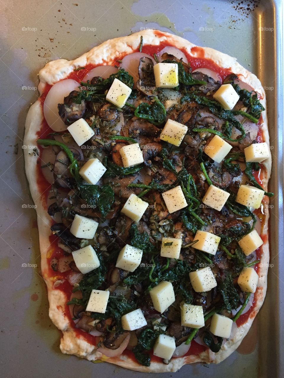 A work in progress: Delicious homemade mushroom, potato, and spinach pizza BEFORE going in the oven!